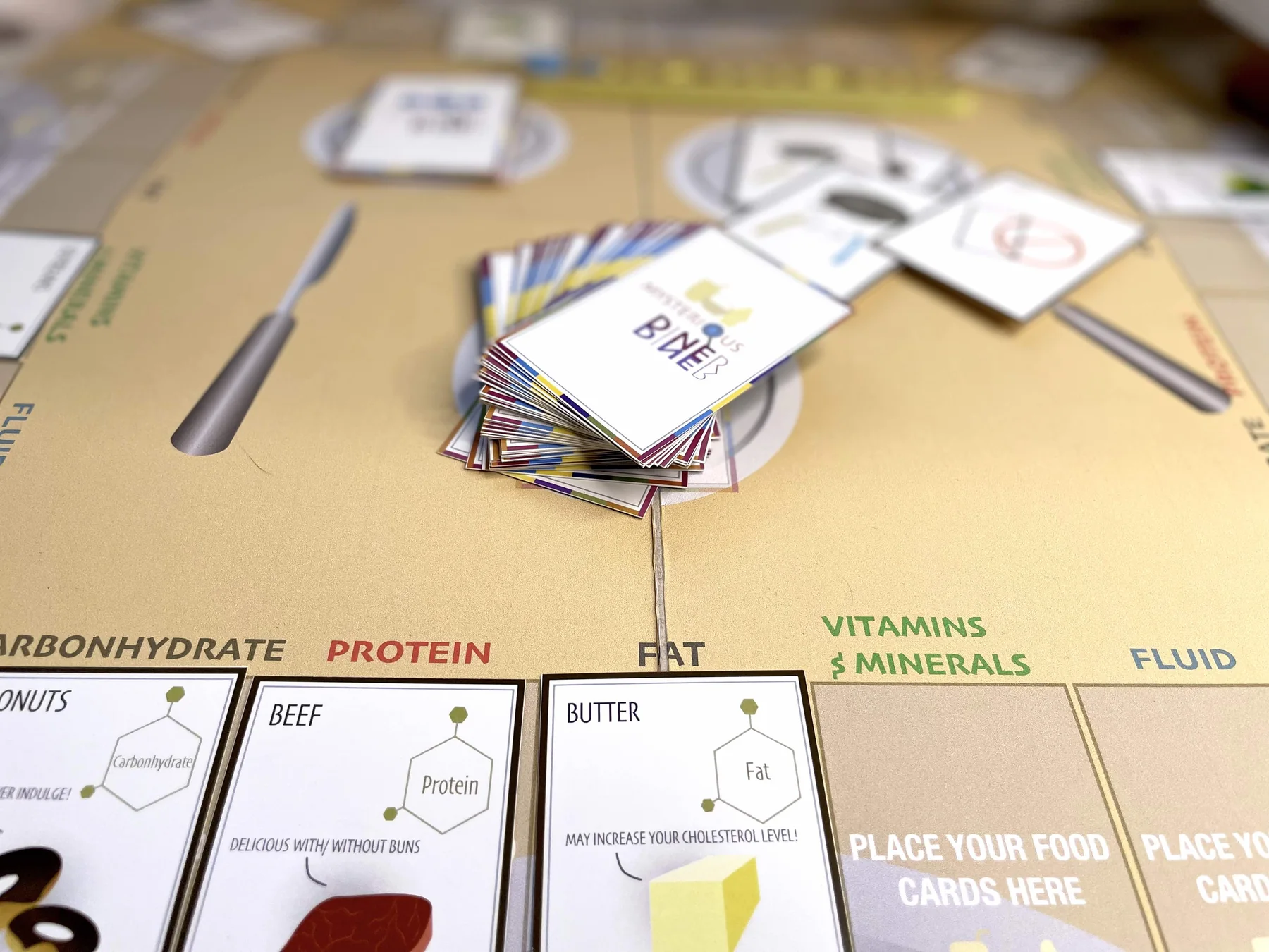 Players around the Mysterious Diner board
